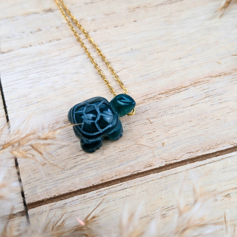 Green Agate Turtle Necklace displayed flat with a soft backdrop