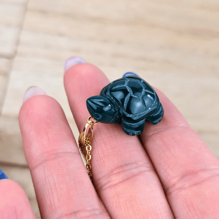Detailed view of the carved Green Agate Turtle pendant.