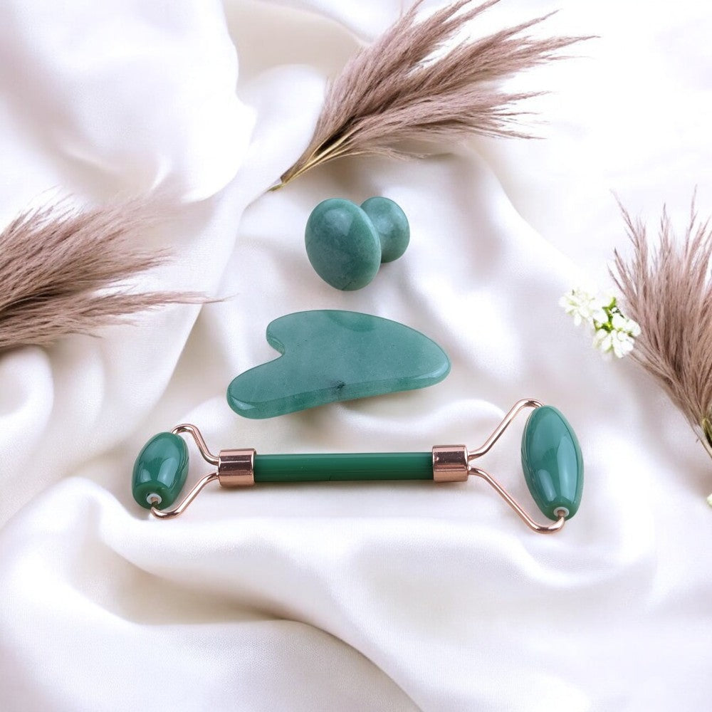 Natural green aventurine massage tools displayed on a soft white background.