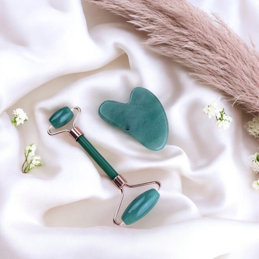 Facial roller made of green aventurine with rose gold accents.