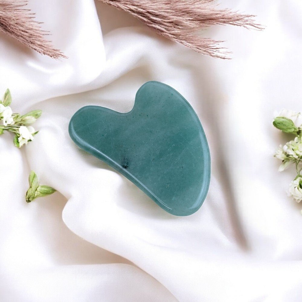 Polished aventurine gua sha tool for facial contouring.