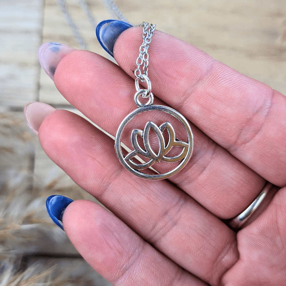 Close-up of a lotus pendant symbolizing spiritual growth and trust.