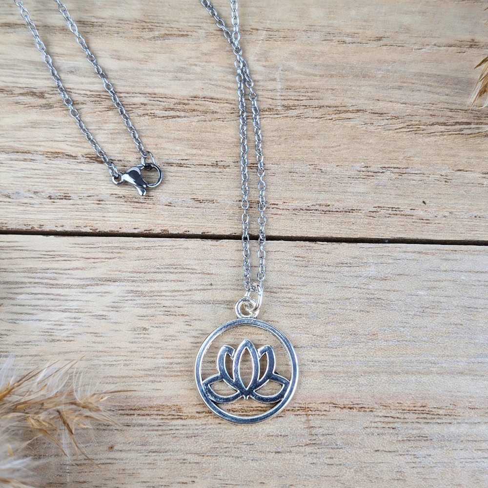 Guiding Lotus Necklace displayed on a wooden background.