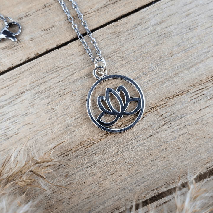 Elegant silver-tone necklace with a lotus design, perfect for spiritual journeys.