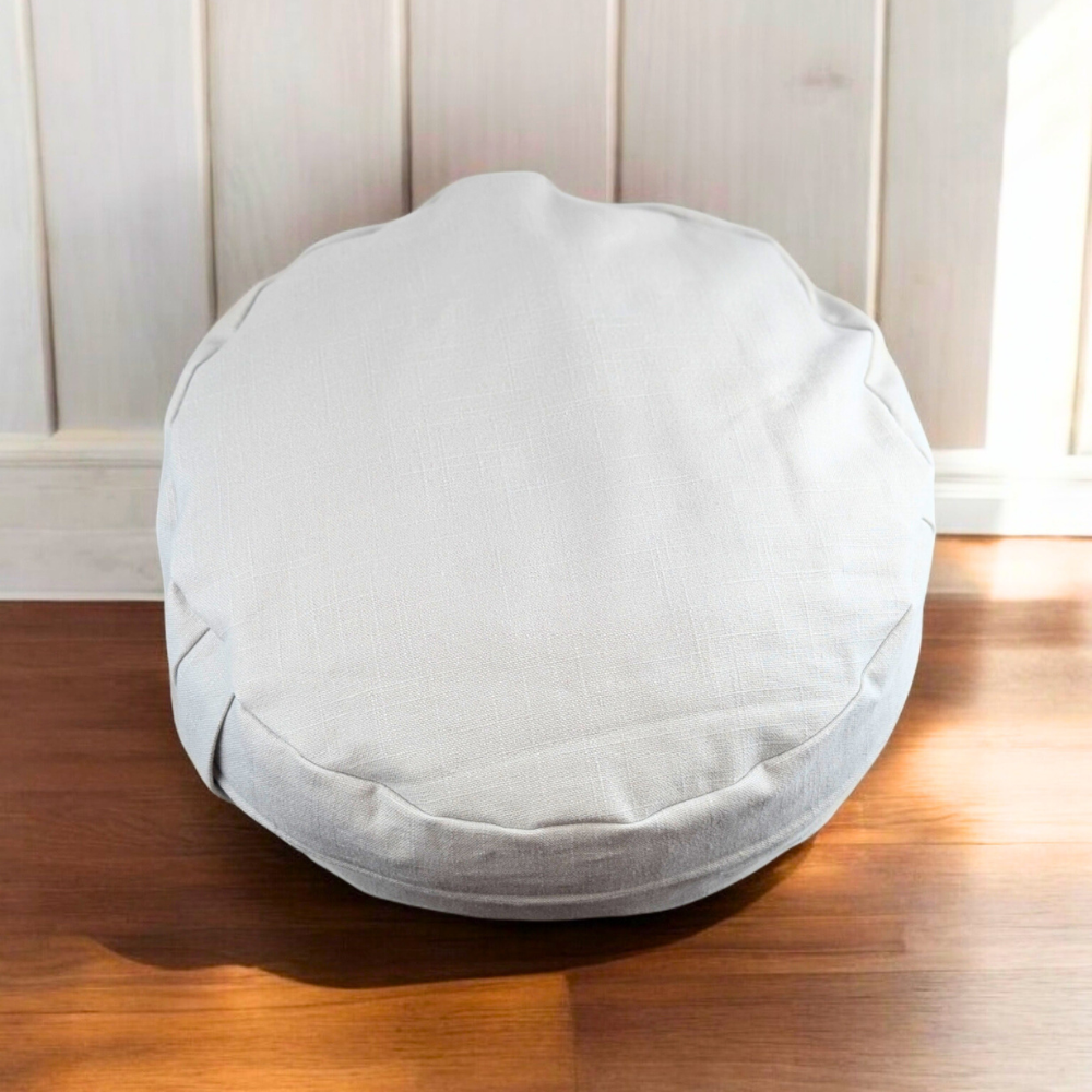 Heather Grey Meditation Pillow on a wooden floor