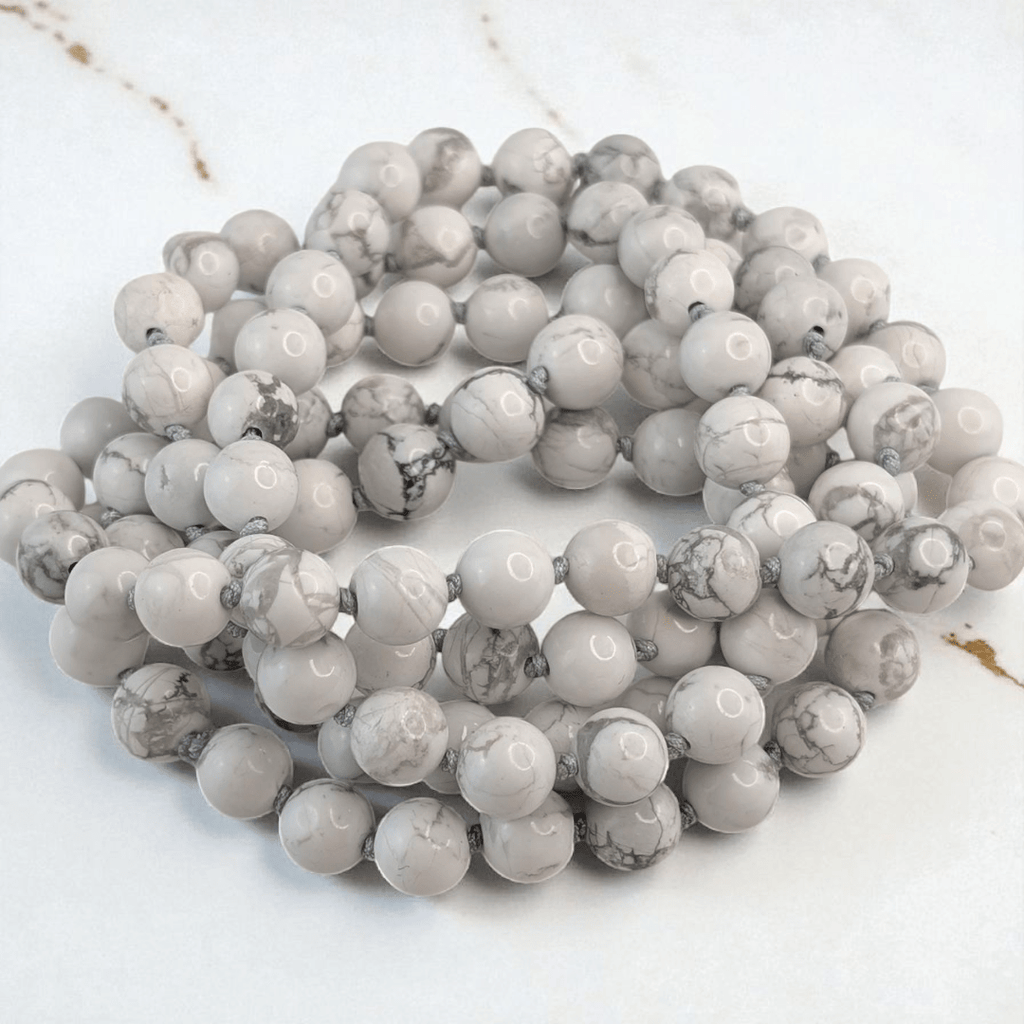hand knotted howlite crystal mala with 108 beads on a white background. Available at at Zen Collection Metaphysical store