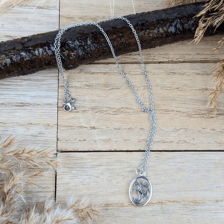 Inner Peace Pendant Necklace with an Om symbol in an oval silver frame.