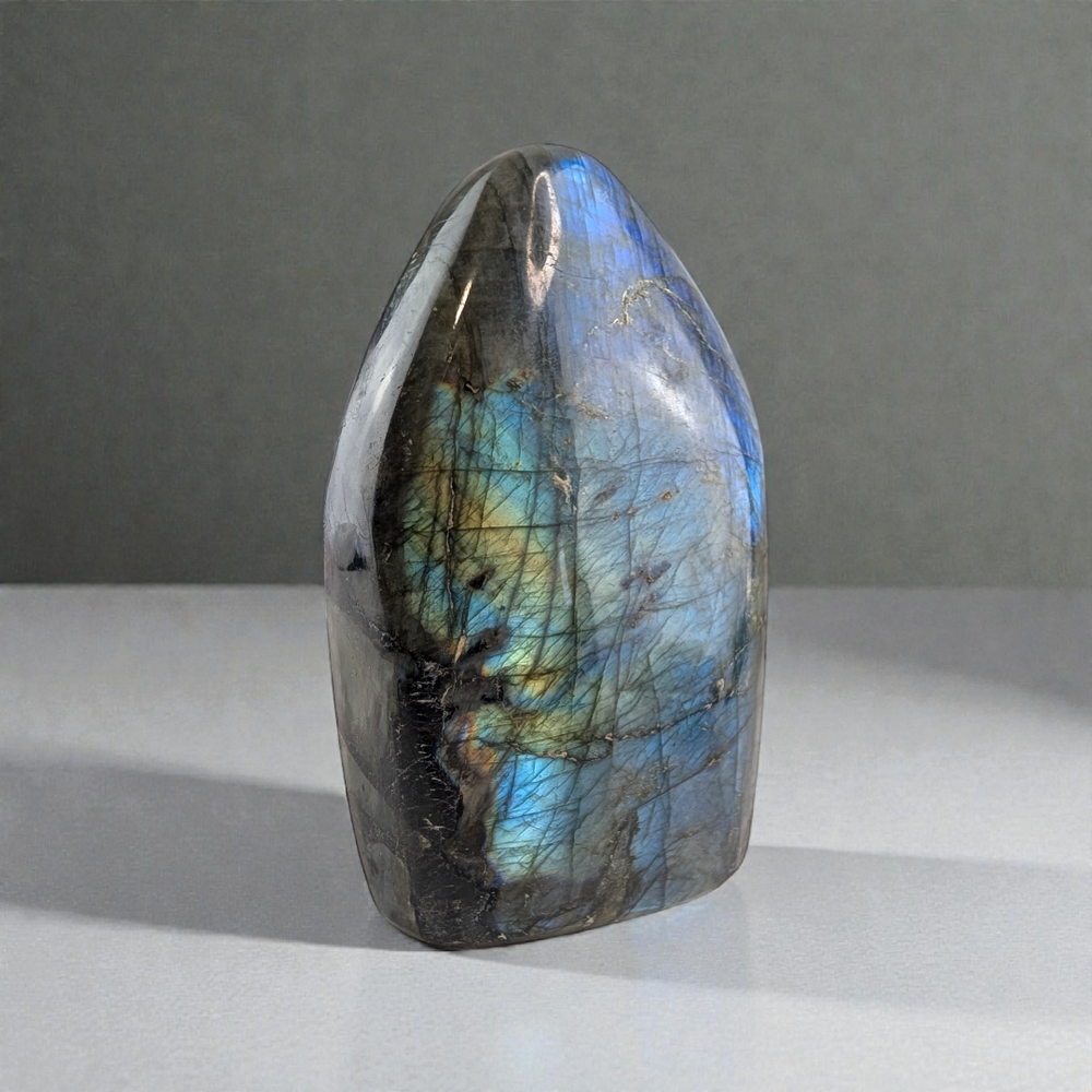 Third Eye Chakra Labradorite stone with multicolored patterns on a gray background available at Zen Collection Metaphysical Store in Barrie. Shop In-store or Online Now 