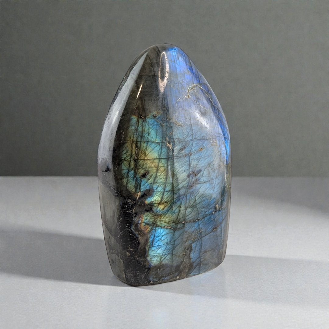 Third Eye Chakra Labradorite stone with multicolored patterns on a gray background available at Zen Collection Metaphysical Store in Barrie. Shop In-store or Online Now 