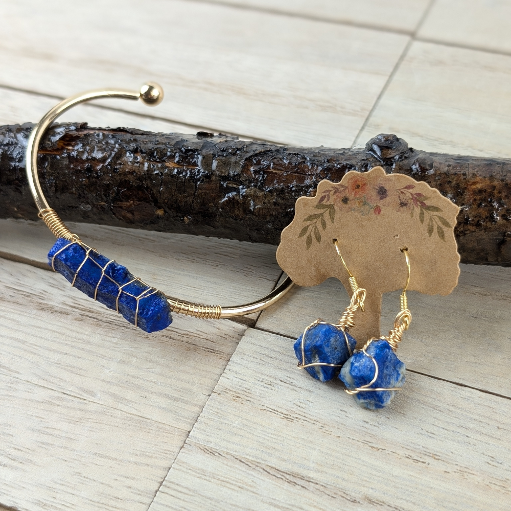 Wire-wrapped Lapis Lazuli jewelry set on a wooden background