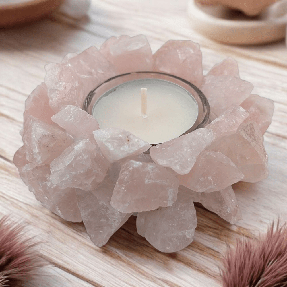 Candle holder made of rose quartz crystals on a wooden surface