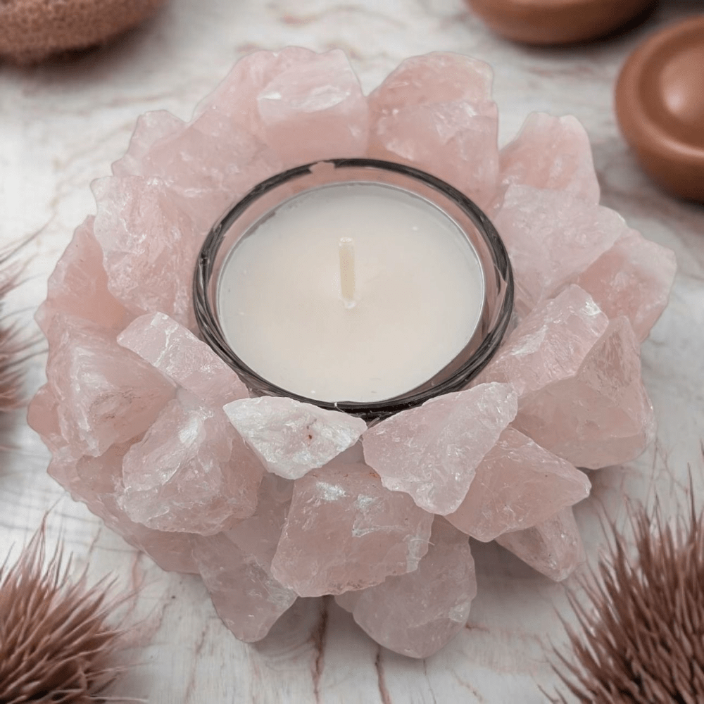 Candle holder made of rose quartz stones on a neutral background