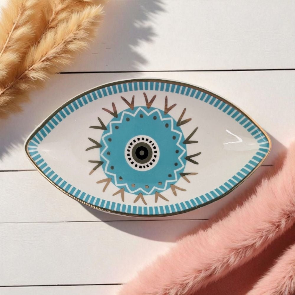 Decorative plate with eye design on a wooden surface