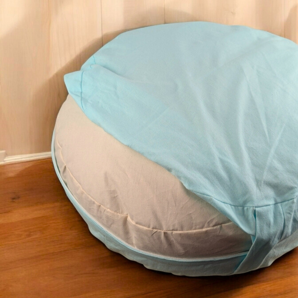 Mint green zafu cushion in a meditation space