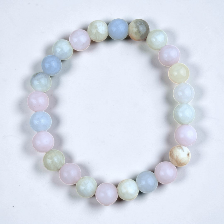 Morganite Crystal Bracelet resting on a rustic wooden surface.