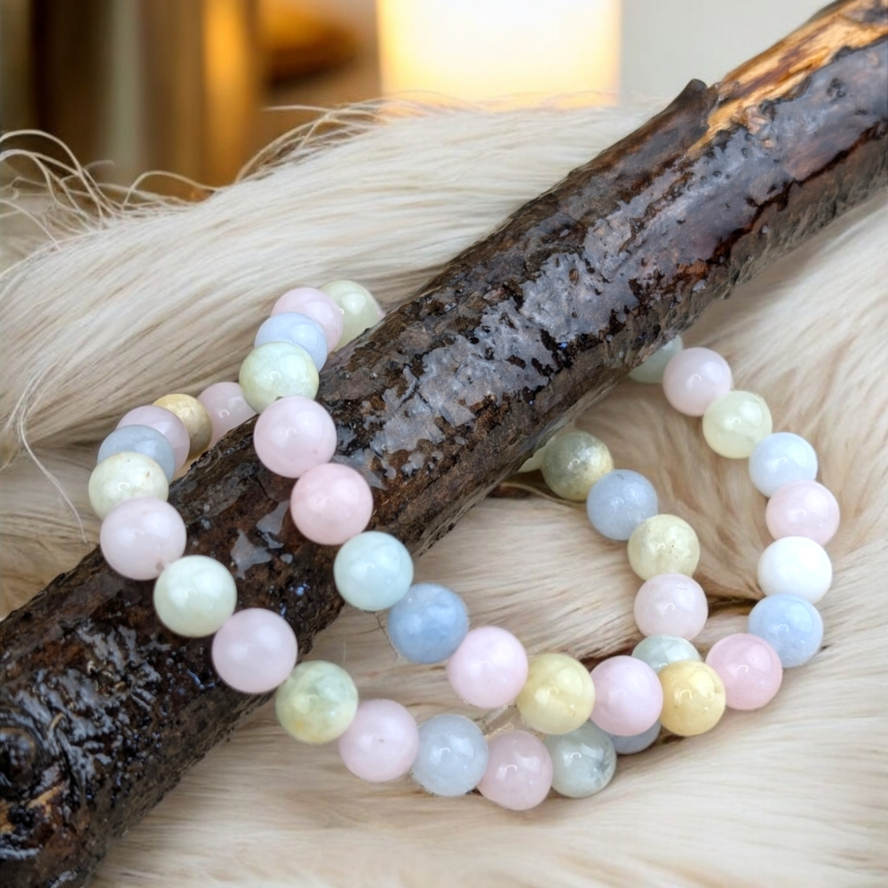 Morganite Crystal Bracelet resting on a rustic wooden surface.