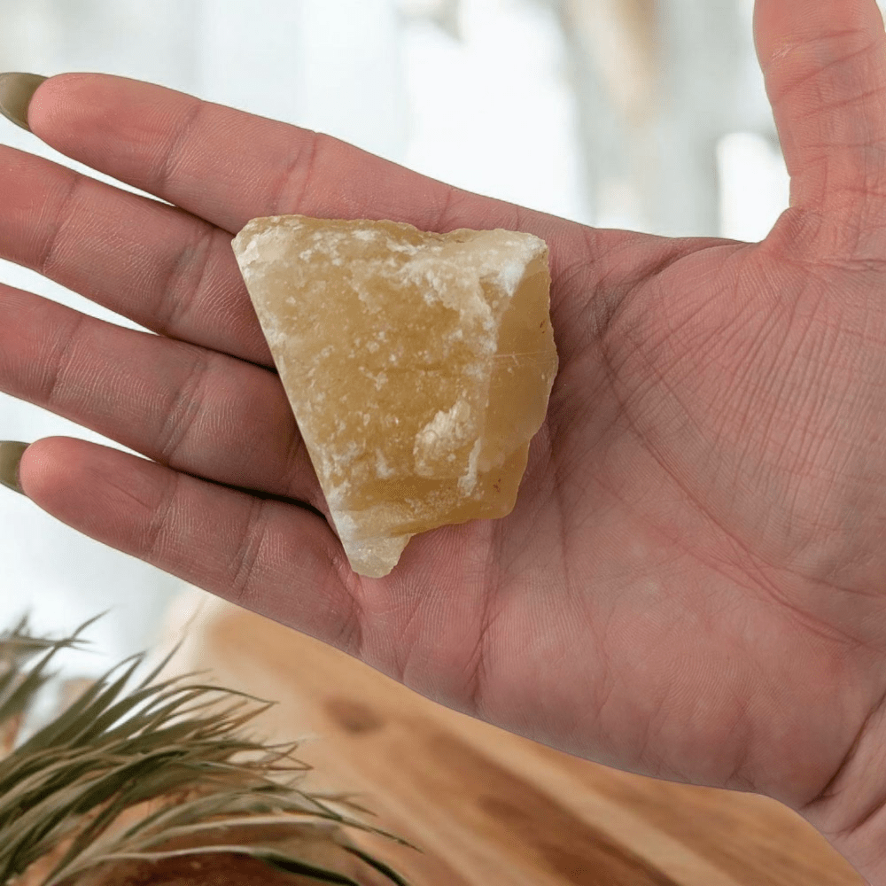 Orange Calcite raw crystal chunk on neutral surface