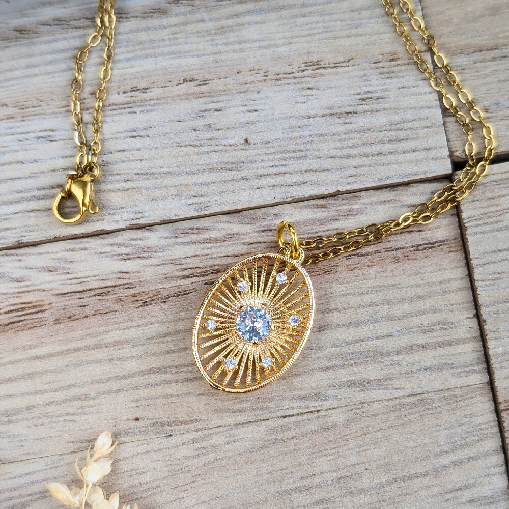 Gold sunburst necklace with sparkling cubic zirconia, symbol of joy and positivity.