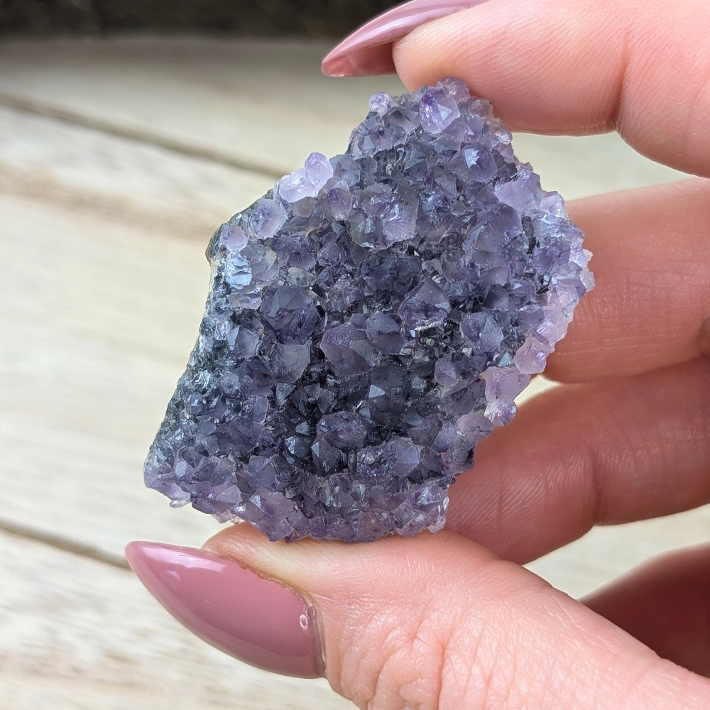 Vibrant Amethyst cluster with rainbow finish for chakra alignment.