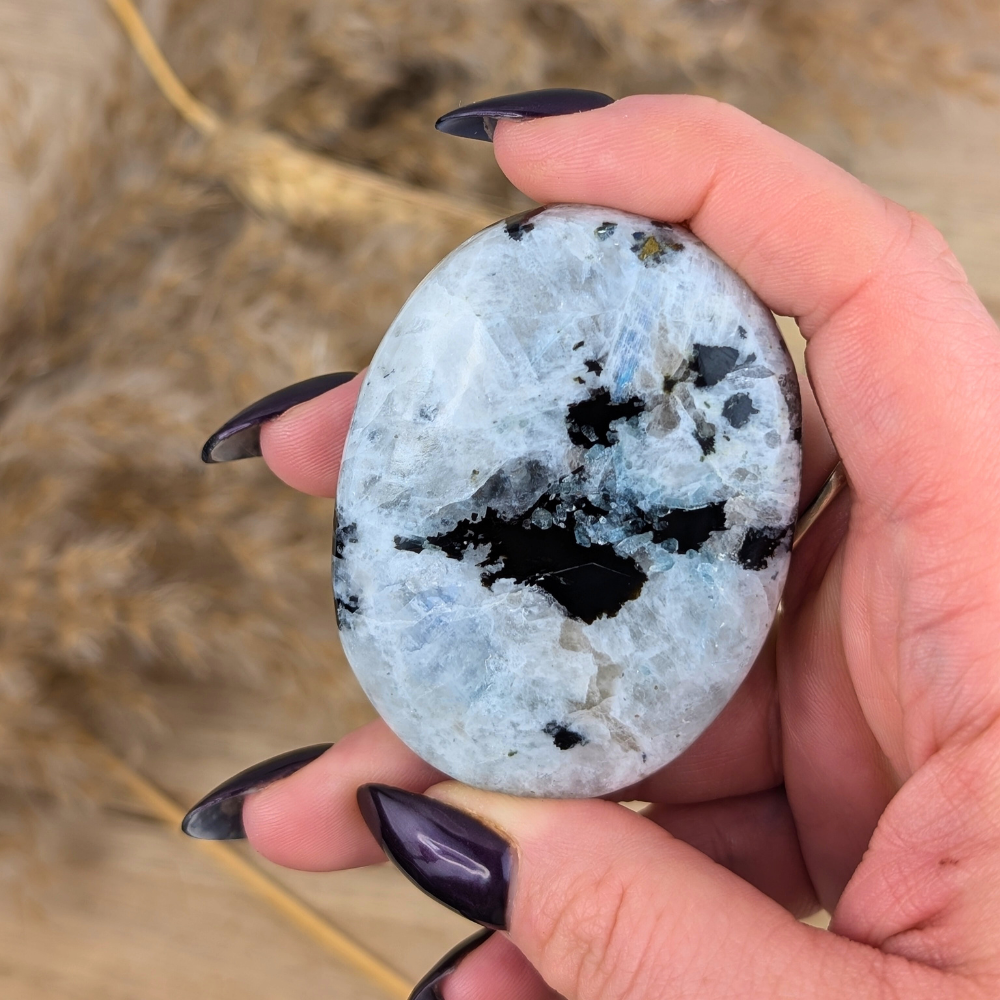 Close-up of Rainbow Moonstone Palm Stone showing shimmering details