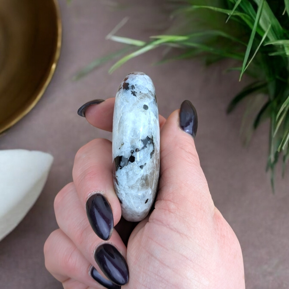 Polished Rainbow Moonstone Palm Stone in soft natural light