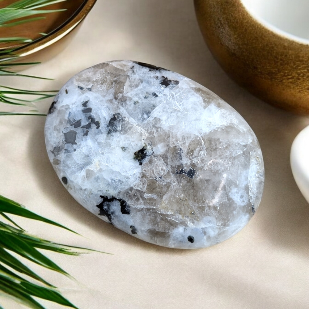 Smooth Rainbow Moonstone Palm Stone used for meditation.