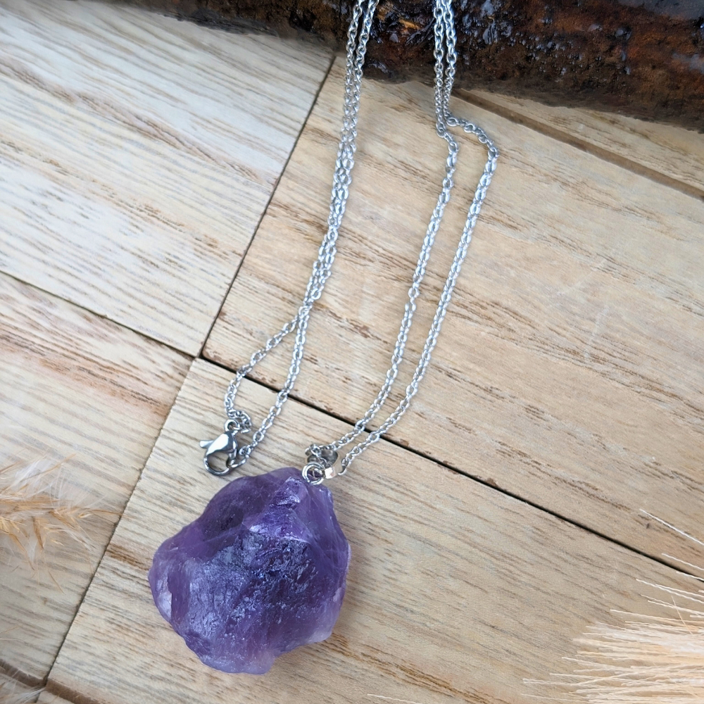 Natural amethyst pendant on a silver-tone chain.