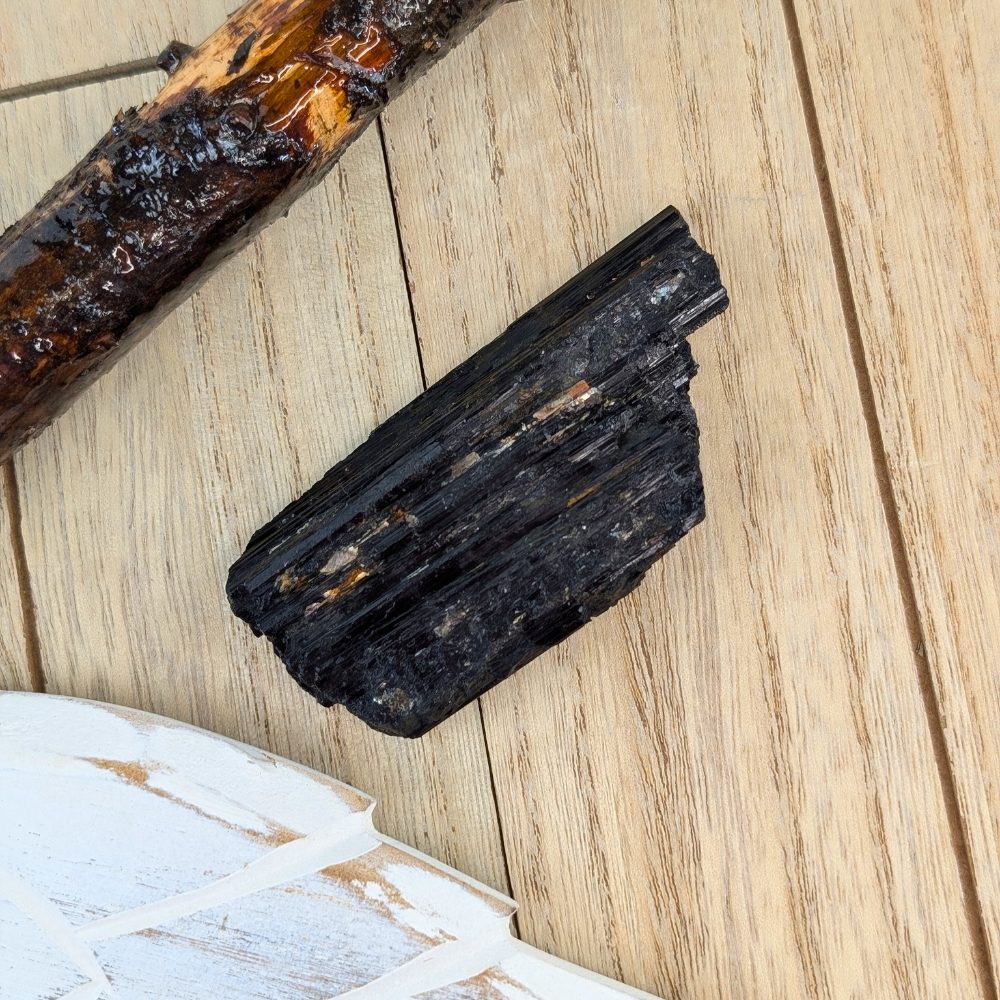 Black Tourmaline Chunk with Vertical Striations - A close-up view of the raw Black Tourmaline chunk’s natural vertical striations, enhancing its ability to shield against negative energy.