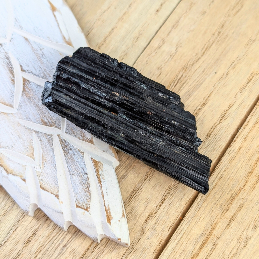 Black Tourmaline with Natural Vertical Striations - A close-up shot of the vertical striations on the raw Black Tourmaline, known for its ability to absorb negative energy and offer protection.