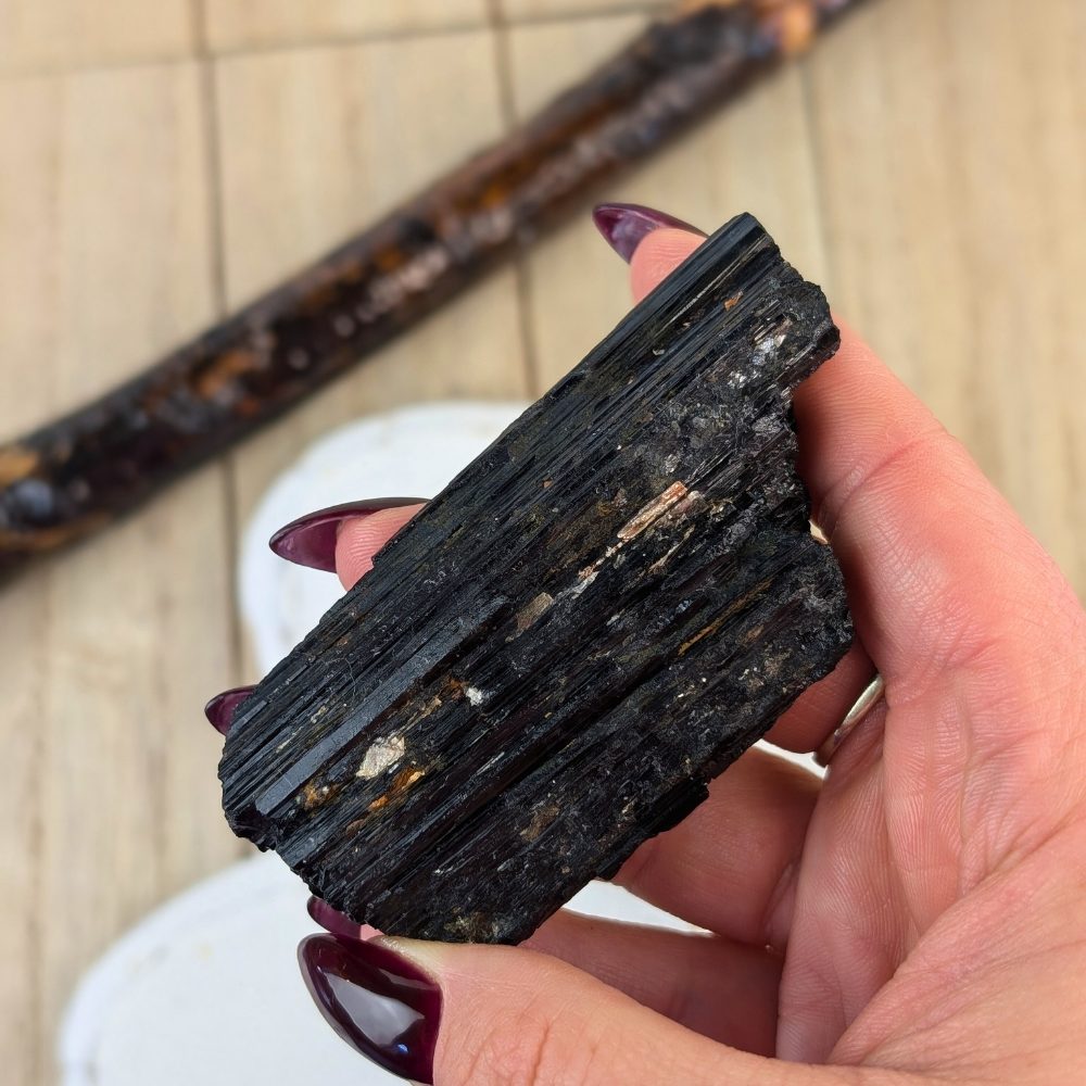 Raw Black Tourmaline Crystal for Energy Cleansing - A Black Tourmaline crystal positioned on a neutral background, perfect for home or personal energy cleansing and protection.