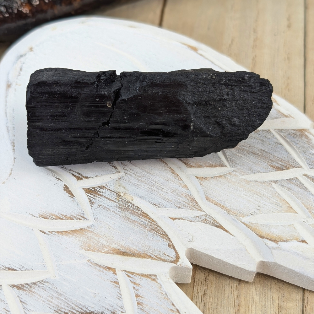 Close-up of Raw Black Tourmaline Chunk - Close-up of the rough surface of the Black Tourmaline chunk, showcasing its natural texture and grounding energy.