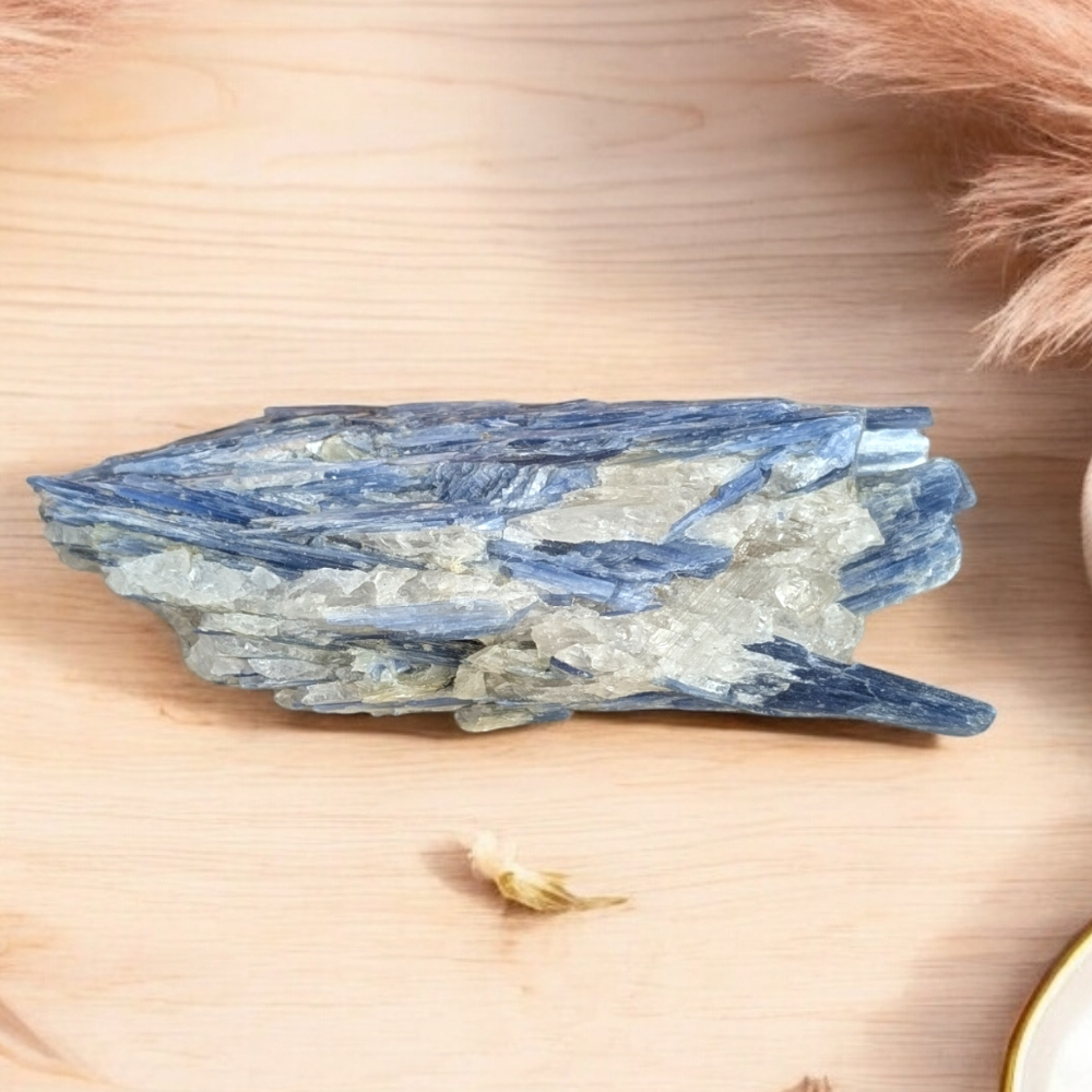 Raw Blue Kyanite Cluster with natural shimmering layers held in hand.