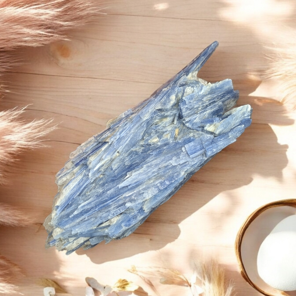 Hand holding Raw Blue Kyanite Cluster for energy clearing.