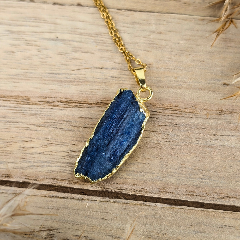 Raw Kyanite Necklace with a natural stone pendant and gold-tone chain.