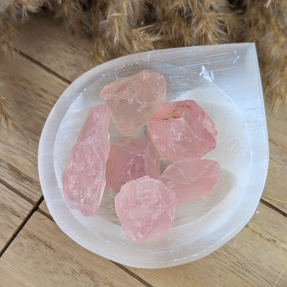 Raw rose quartz crystals for emotional healing and heart chakra alignment.