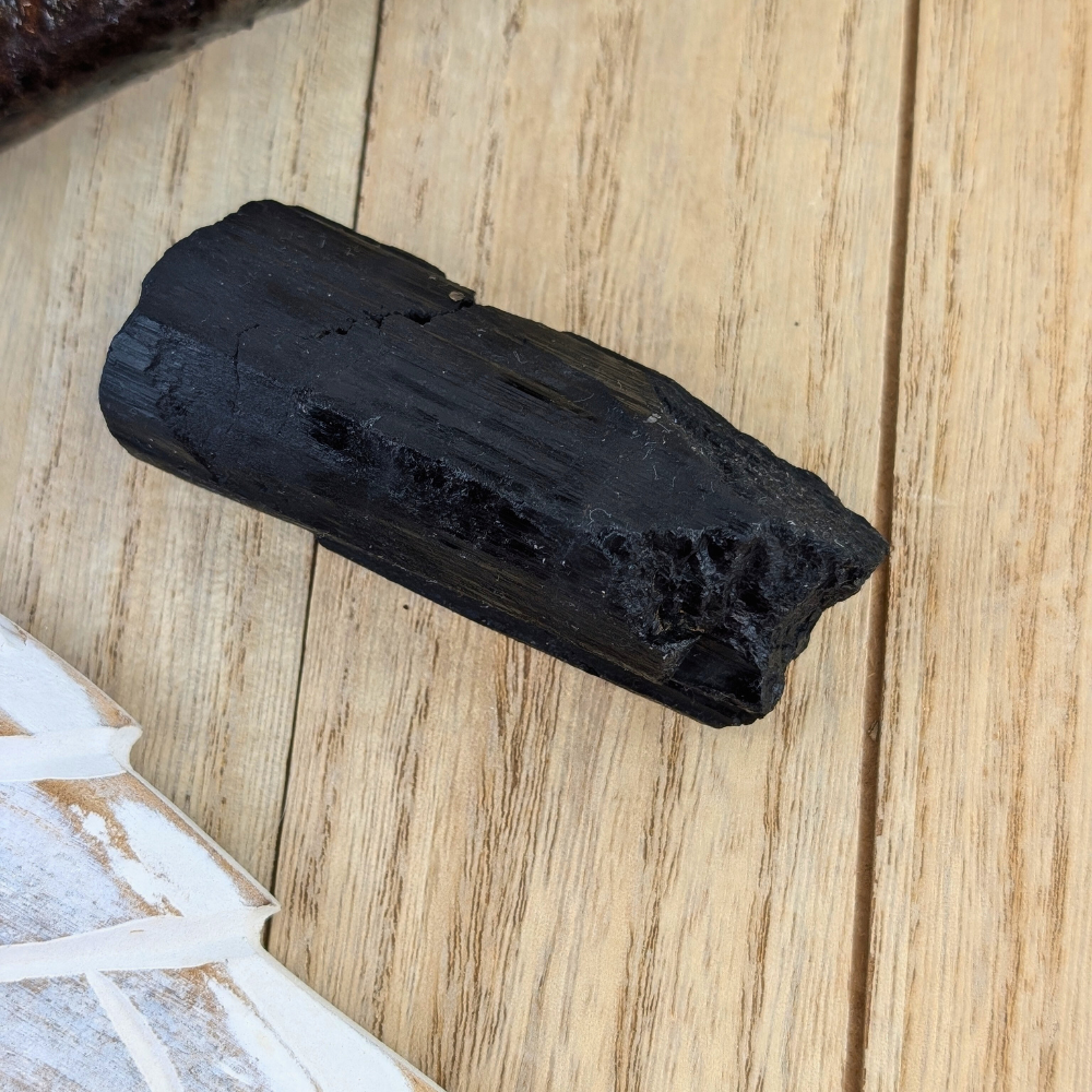 Raw Black Tourmaline Crystal for Grounding and Shielding - Black Tourmaline chunk placed on a clean background, great for grounding and protection rituals.