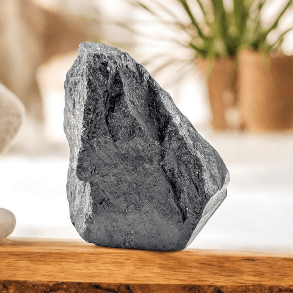 Raw Black Tourmaline crystal on white surface