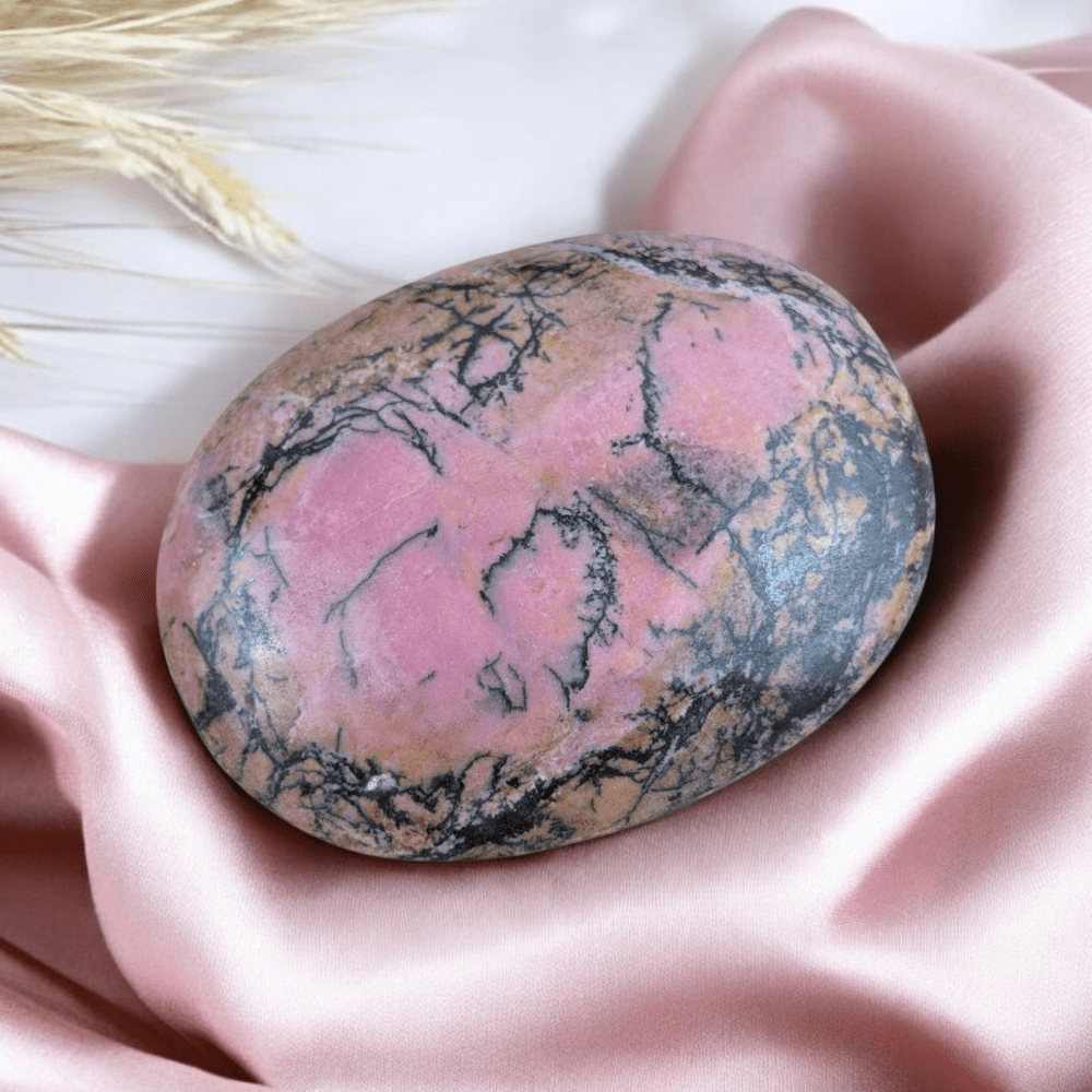 Ethically sourced Rhodonite crystal palm stone from Zen Collection