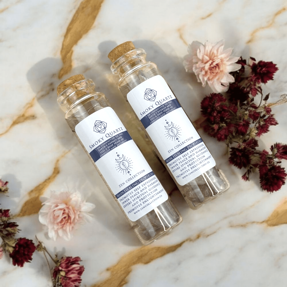 Two glass bottles labeled 'Smoky Quartz' on a marble surface with flowers.