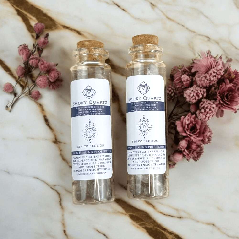 Two Smoky Quartz bottles on a marble surface with flowers.