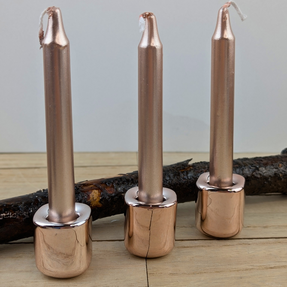 Elegant metallic rose gold candle holder for spiritual practices