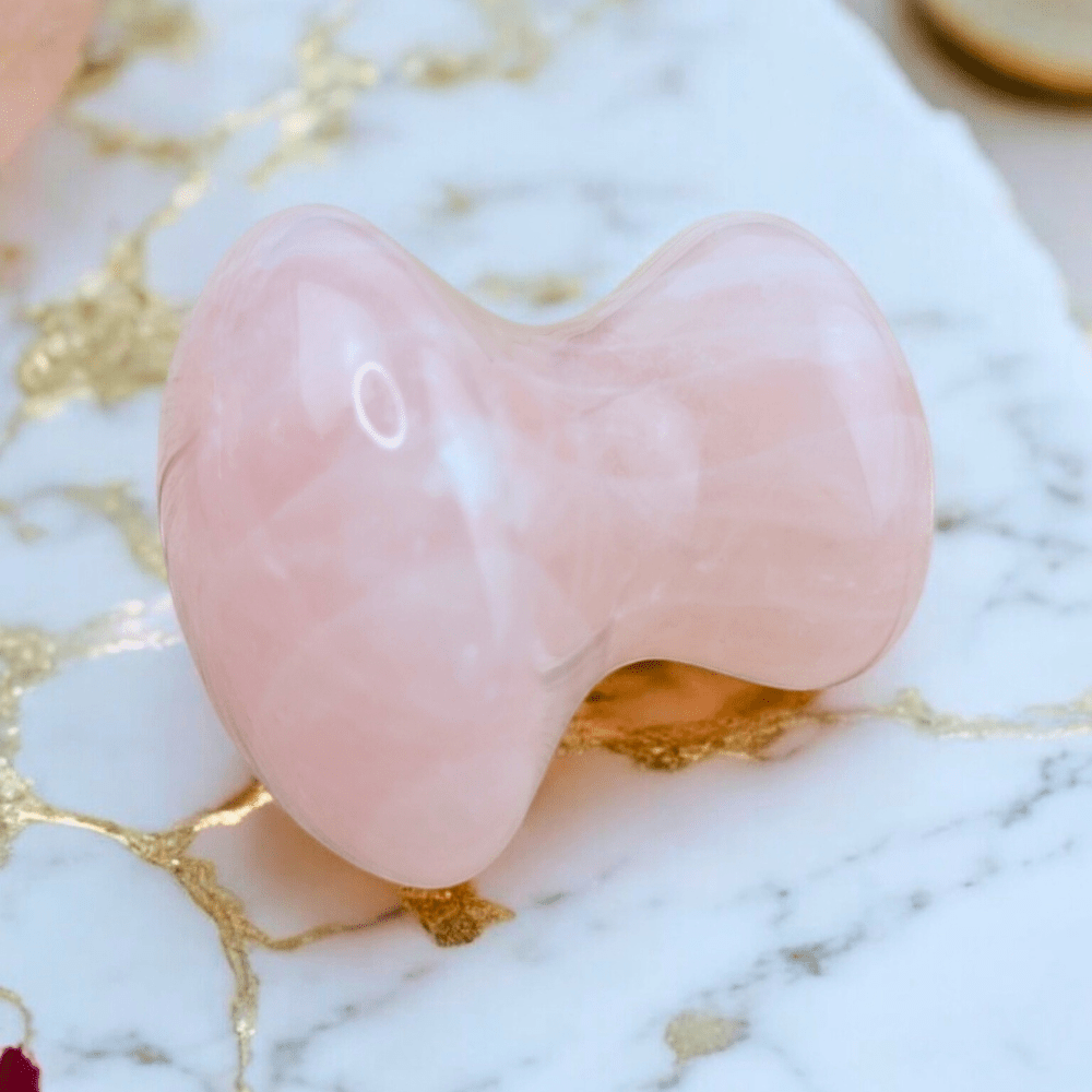 Heart-shaped rose quartz gua sha for facial massage.