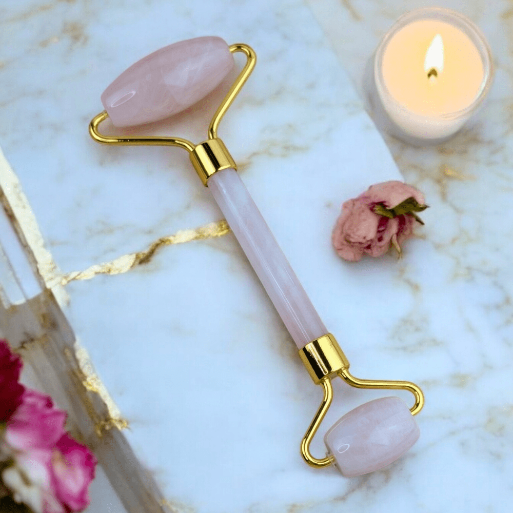 Close-up of rose quartz crystal facial roller.