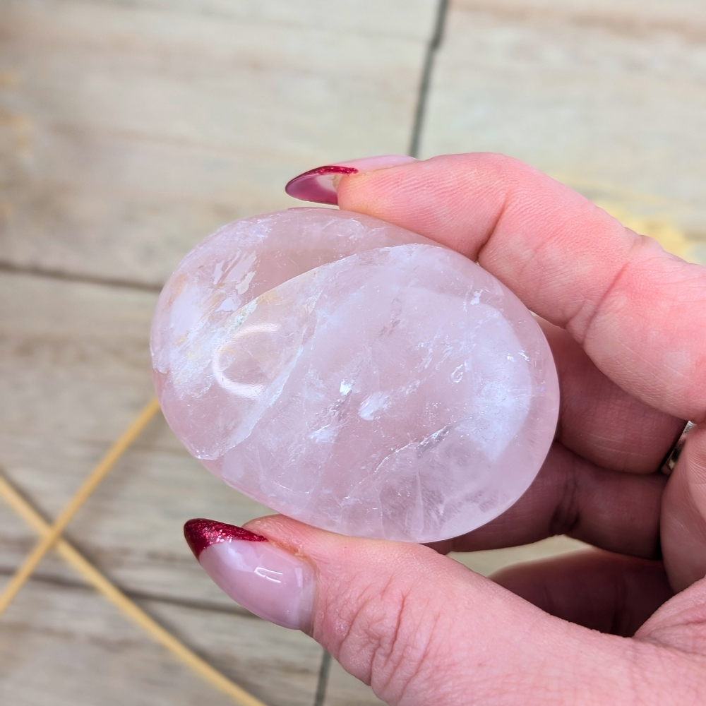 Heart-healing rose quartz palm stone for meditation and chakra alignment.