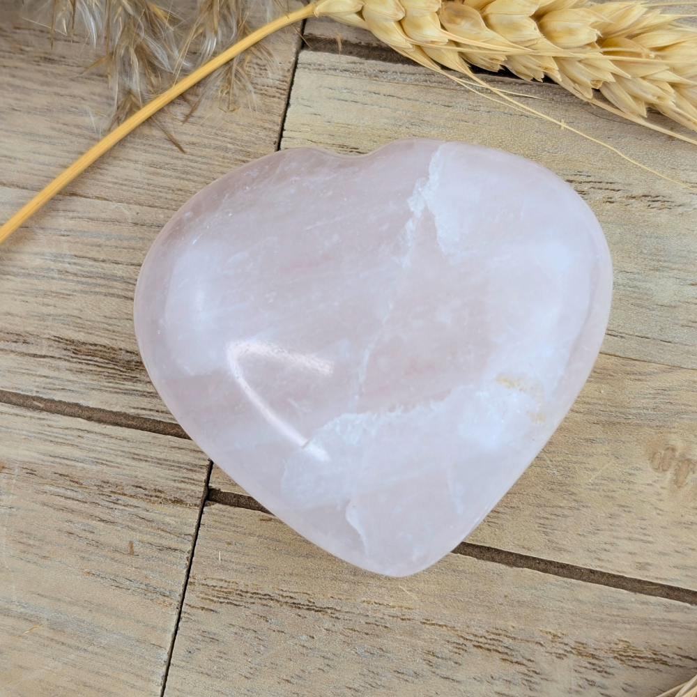 Heart-shaped rose quartz crystal for balancing energy centers and self-care.