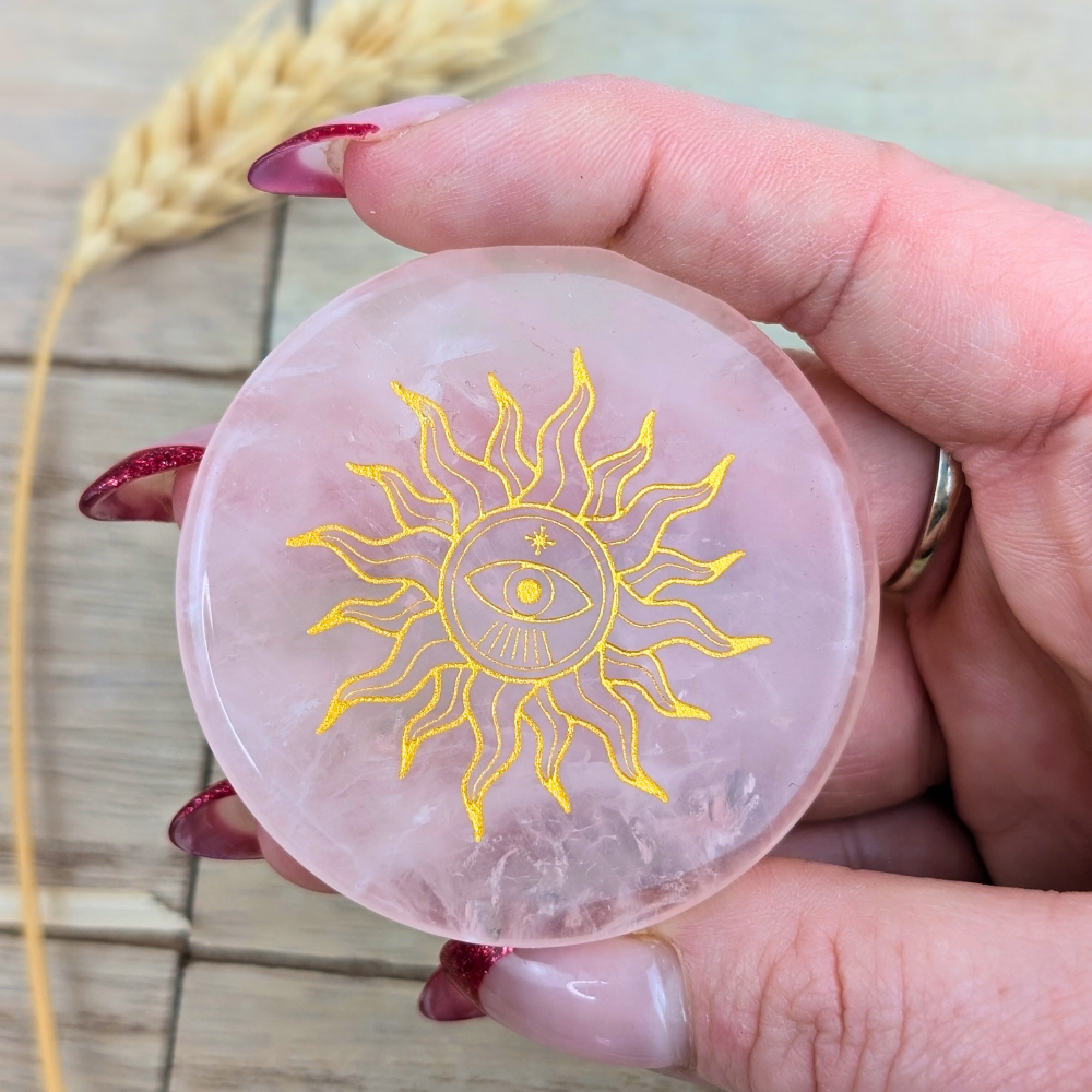 Engraved rose quartz crystal plate with soft pink hue for energy alignment.