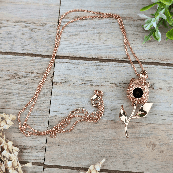 Rose gold diffuser necklace releasing essential oil fragrance