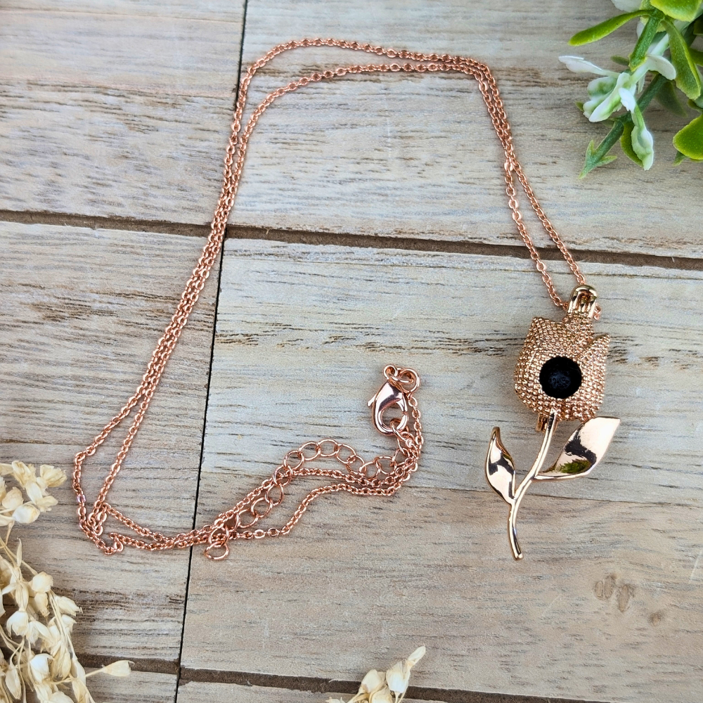 Rose gold diffuser necklace releasing essential oil fragrance