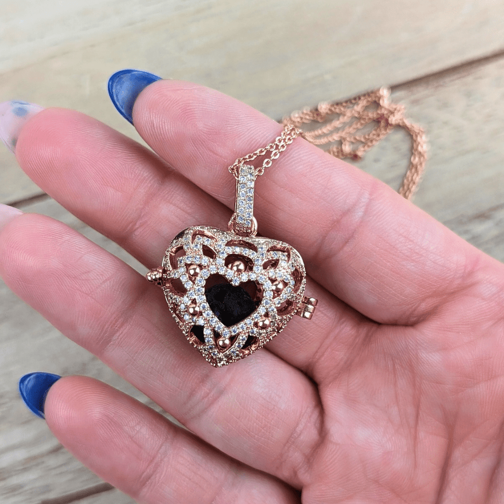 Rose gold diffuser locket with intricate filigree design