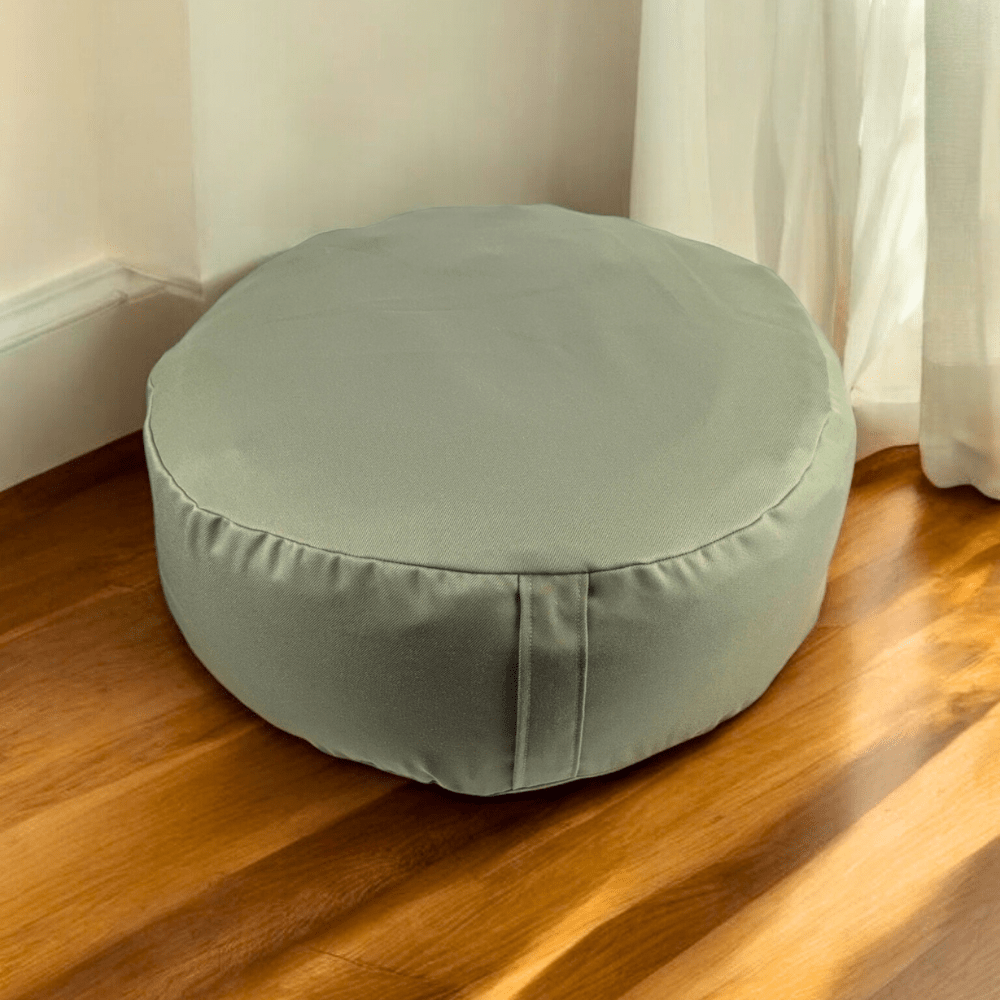 Cotton meditation pillow on a wooden floor.